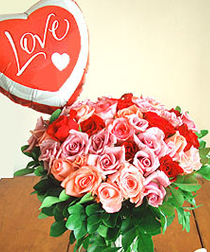 Heartsong's A Flutter - Bouquet includes one dozen of our best-selling pink and lilac roses mixed with gorgeous reds, and a 9-inch foil balloon, shaped like a heart with the words: LOVE. *Vase not included. Every Bouquet is elegantly hand- wrapped in non- woven fabric with a paper twine ribbon. includes: A greeting card with your personal message. Delivered with great care in our distinctive handmade boxes. The box includes care instructions.<br><br>Code:608-9387-608-0000110113